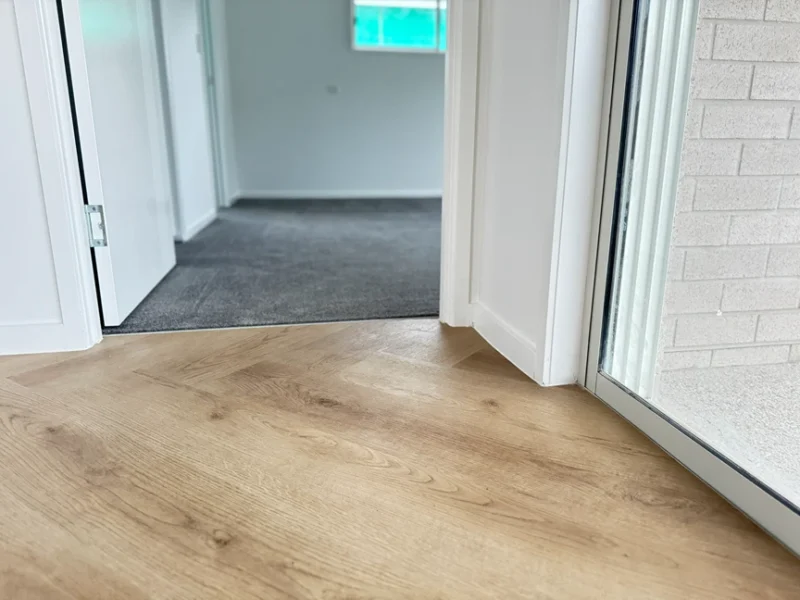 Laminate flooring installed in a clean modern hallway
